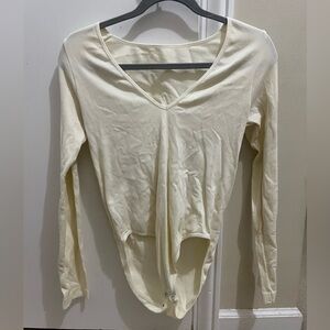 White body suit. No tag for size but fits like a small.